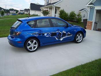 Blue Skull Graphics on Show Car from Weston Signs Inc.  Ripped Torn Metal with Extra Style